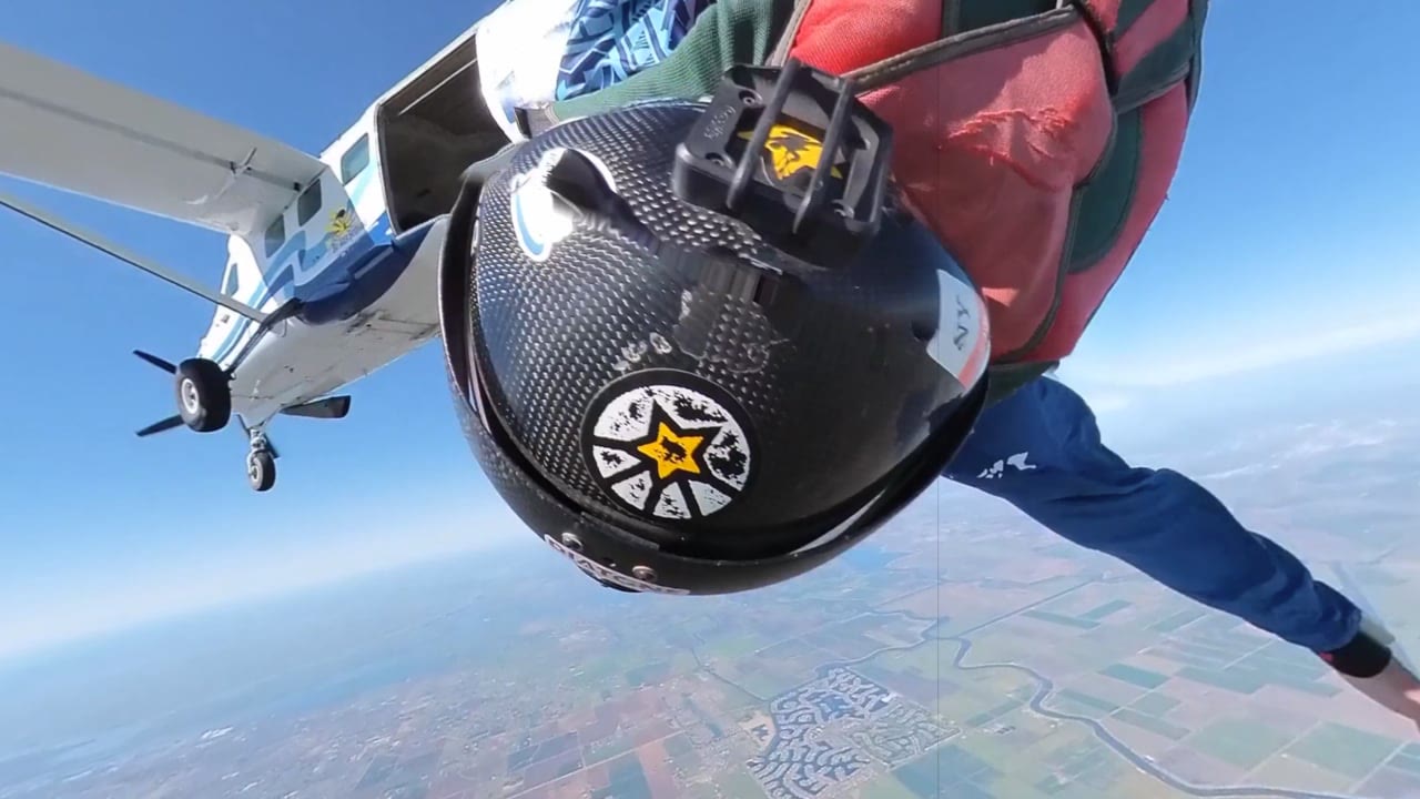 A skydiver leaving an aircraft above the landscape, from Nathan’s published Epic Skydive Adventure
