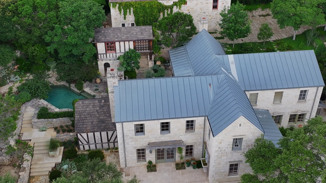 Aerial view of a stone property and pool in Nathan’s Fredericksburg film